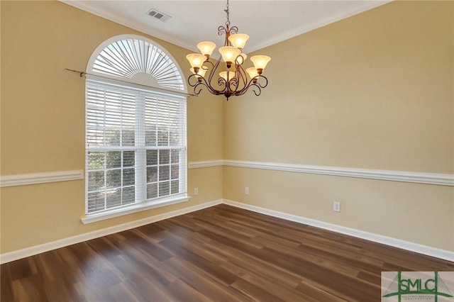 unfurnished room with visible vents, baseboards, ornamental molding, an inviting chandelier, and dark wood-style floors