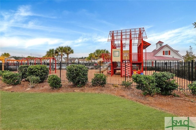 view of yard with playground community and fence