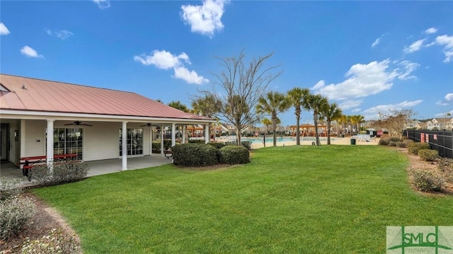 view of yard with a fenced in pool, a patio, a ceiling fan, and fence