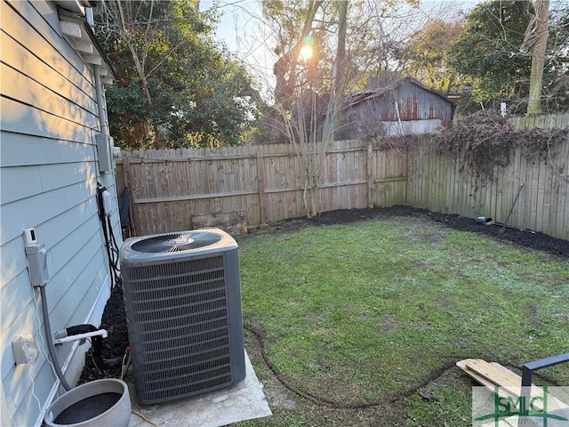 view of yard featuring a fenced backyard and central AC