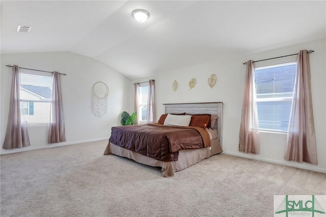 bedroom with visible vents, baseboards, lofted ceiling, and carpet floors