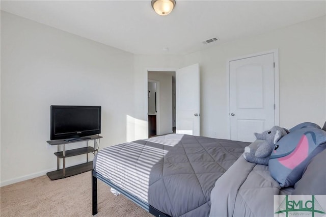 bedroom featuring visible vents, baseboards, and carpet