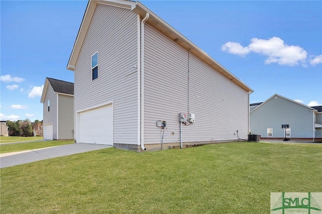 view of side of property with a lawn, driveway, an attached garage, and central AC