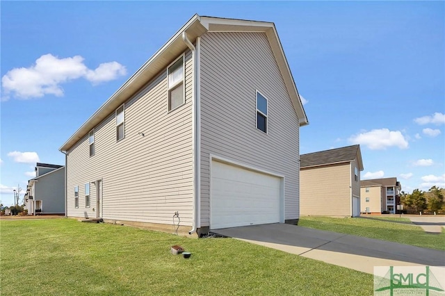 view of side of property with concrete driveway, a yard, and a garage