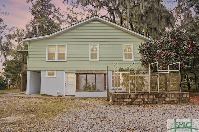 view of back of property at dusk