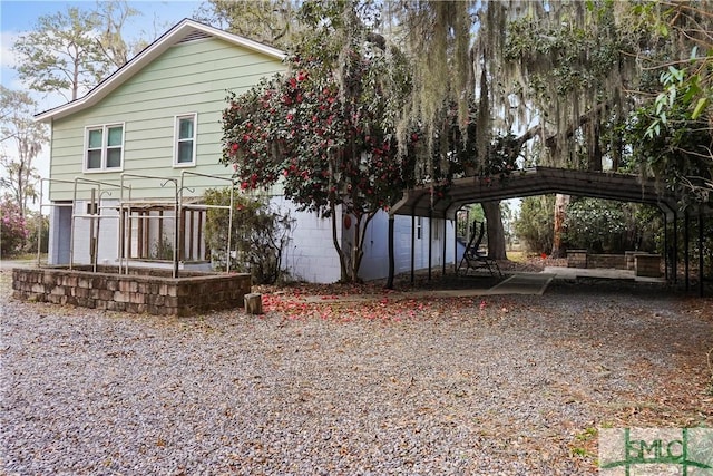 rear view of house with a detached carport and driveway