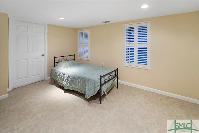 carpeted bedroom featuring recessed lighting, visible vents, and baseboards