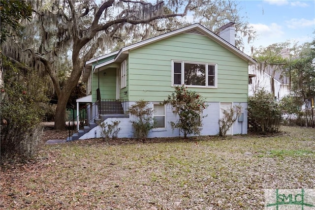 view of side of property with a chimney