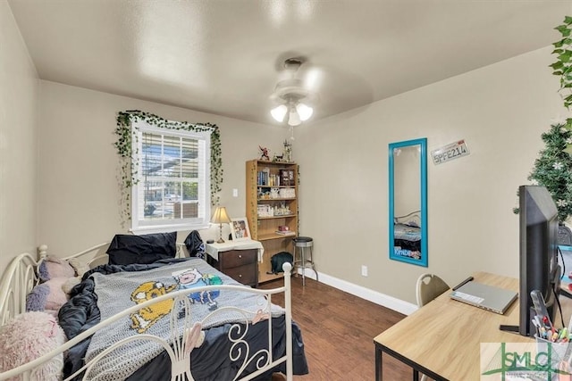 bedroom featuring dark wood-type flooring and baseboards