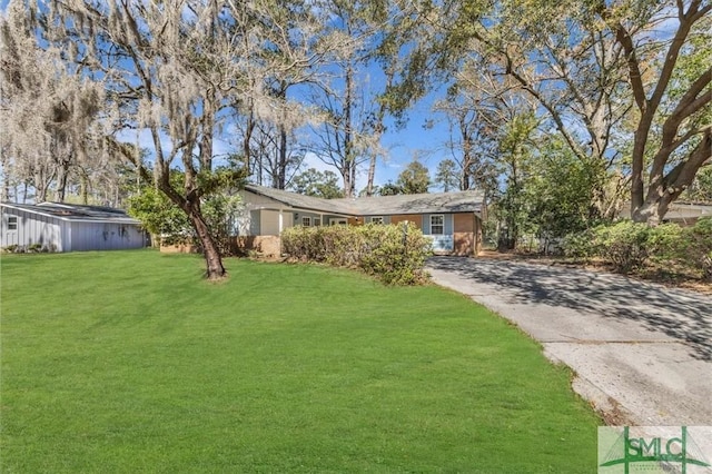 exterior space featuring driveway and a front lawn