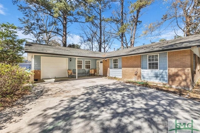 view of front of house featuring a garage, brick siding, and concrete driveway