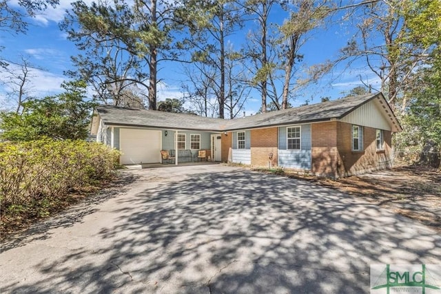 ranch-style house with an attached garage, brick siding, and driveway