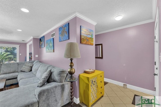 living area featuring light tile patterned floors, visible vents, a textured ceiling, and ornamental molding