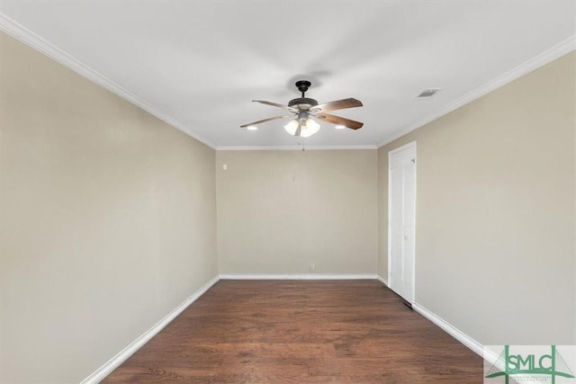 spare room with wood finished floors, a ceiling fan, visible vents, and baseboards