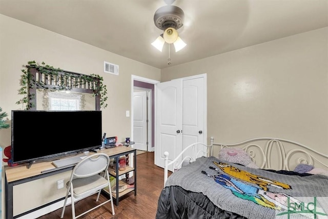 bedroom with visible vents, ceiling fan, and wood finished floors