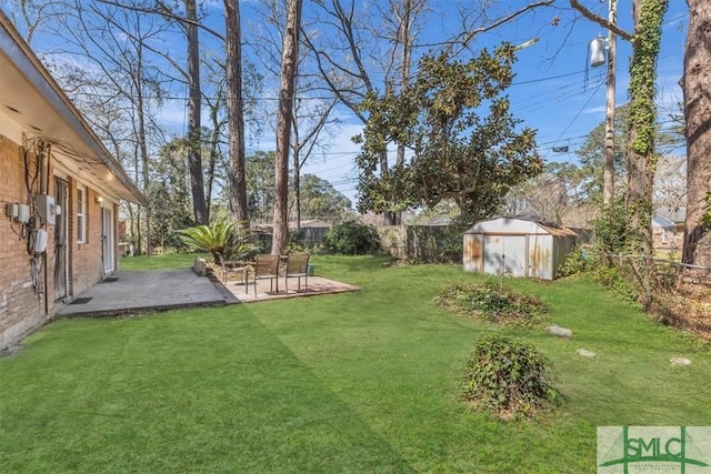 view of yard with an outbuilding, a fenced backyard, a storage shed, and a patio