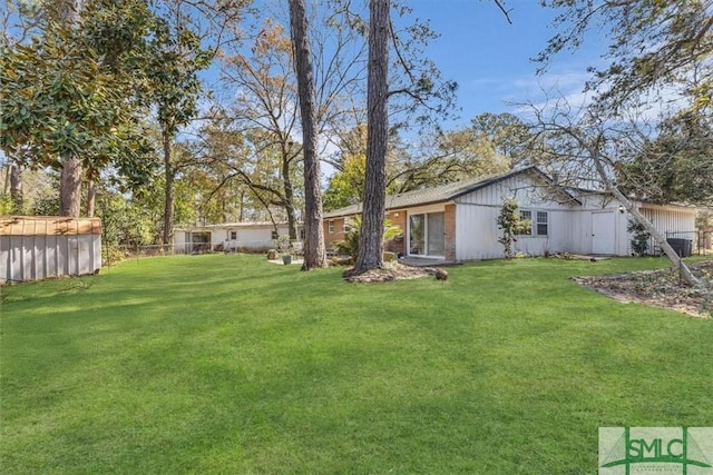 view of yard featuring a pool and fence