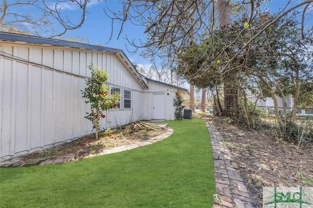 view of yard with cooling unit and fence