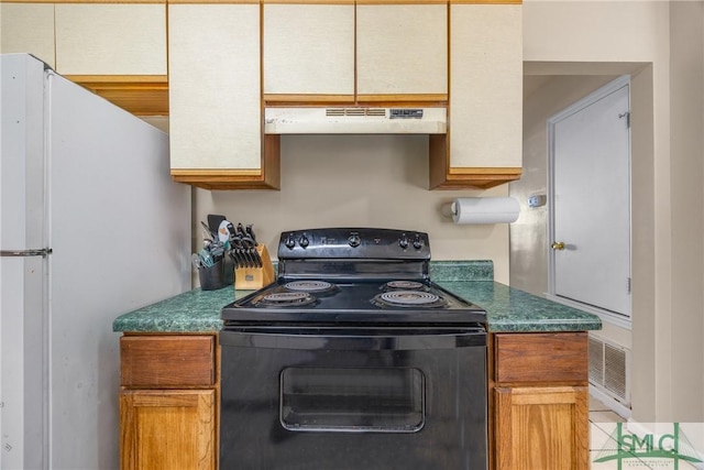 kitchen featuring freestanding refrigerator, dark countertops, black range with electric stovetop, and under cabinet range hood