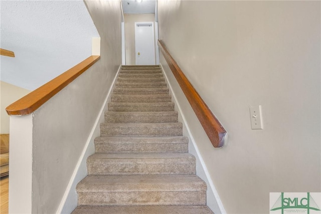 stairs featuring baseboards