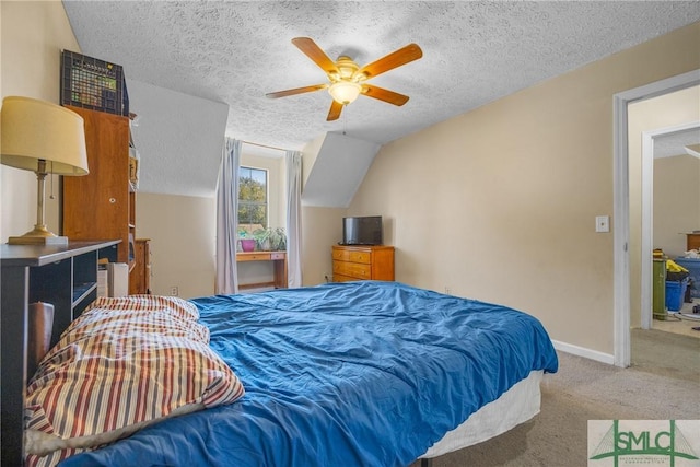 carpeted bedroom featuring baseboards, a textured ceiling, ceiling fan, and vaulted ceiling