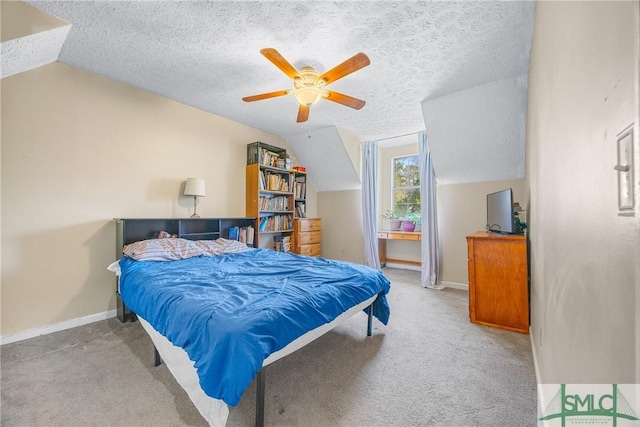 bedroom with vaulted ceiling, carpet, baseboards, and a textured ceiling