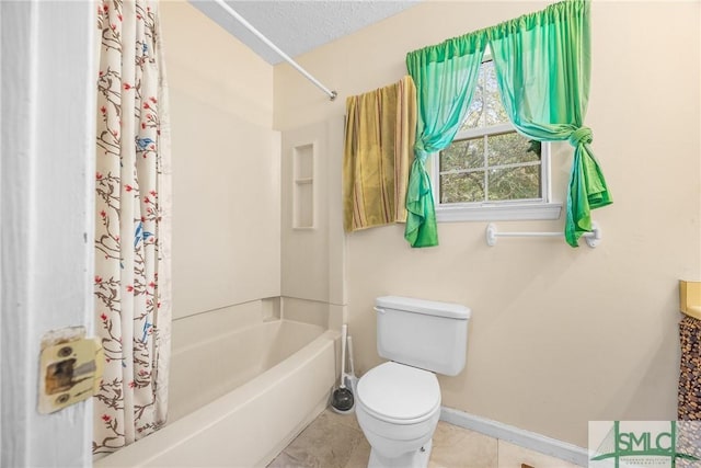 bathroom with baseboards, tile patterned flooring, shower / bath combination with curtain, a textured ceiling, and toilet