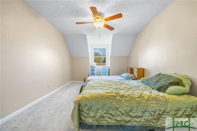 carpeted bedroom with a textured ceiling, a ceiling fan, baseboards, and vaulted ceiling