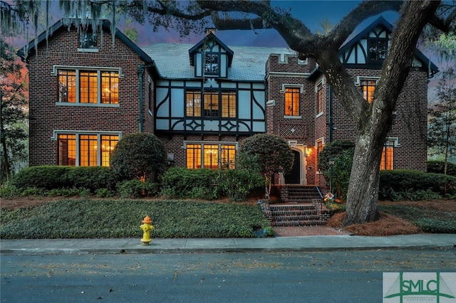 tudor house with brick siding and stucco siding