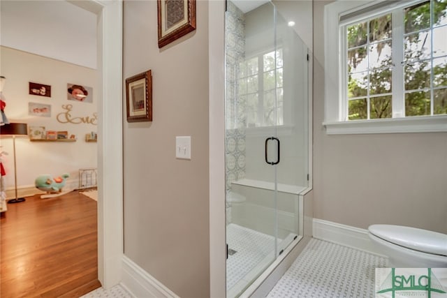 full bathroom with tile patterned flooring, a shower stall, toilet, and baseboards