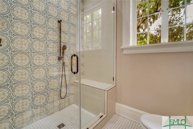 bathroom with a shower stall and toilet