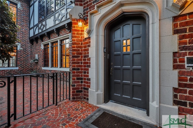 property entrance with brick siding