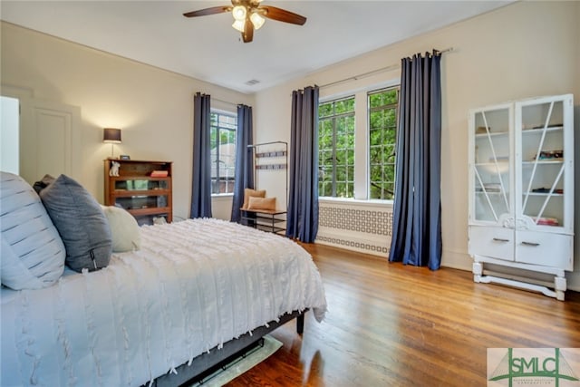 bedroom featuring wood finished floors and ceiling fan