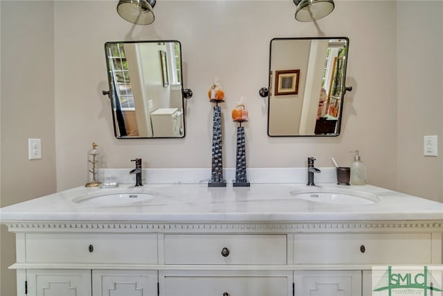 full bathroom with double vanity and a sink