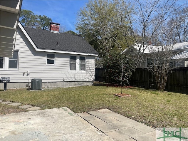 view of yard with a patio area, central air condition unit, and a fenced backyard