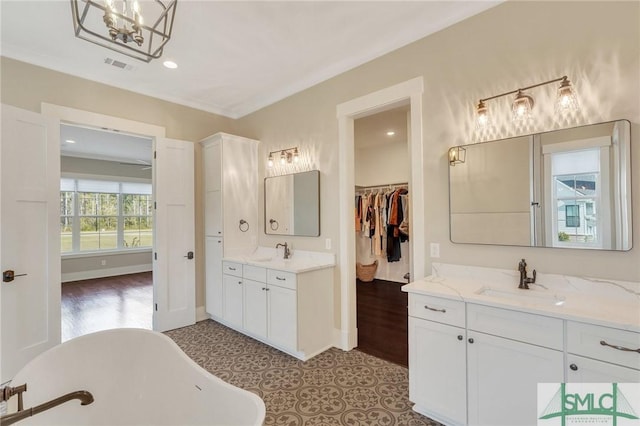 126 Carapace Ct, Richmond Hill, GA 31324 - bathroom featuring a sink, a freestanding tub, two vanities, and visible vents