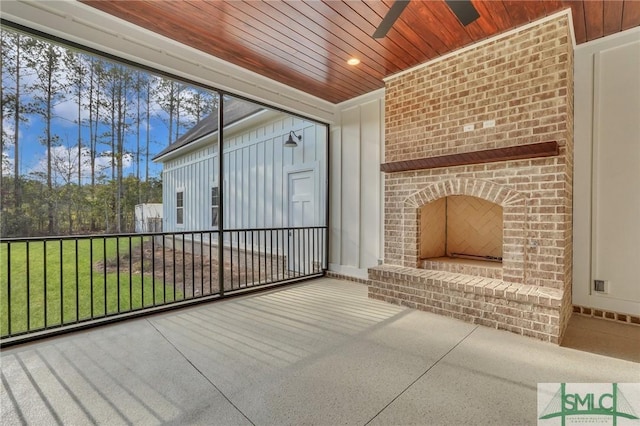 126 Carapace Ct, Richmond Hill, GA 31324 - unfurnished sunroom with a brick fireplace, wood ceiling, and a ceiling fan
