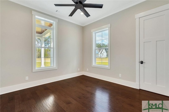 126 Carapace Ct, Richmond Hill, GA 31324 - spare room with visible vents, dark wood-type flooring, a ceiling fan, crown molding, and baseboards