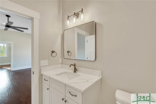 126 Carapace Ct, Richmond Hill, GA 31324 - bathroom featuring baseboards, ceiling fan, toilet, wood finished floors, and vanity