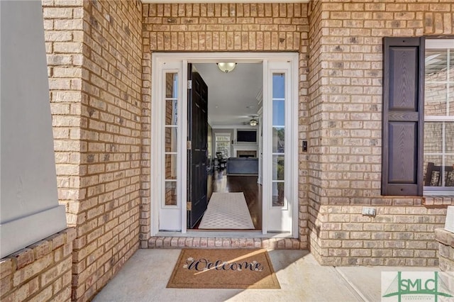 doorway to property featuring stone siding and brick siding