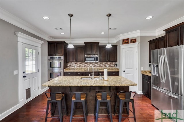 kitchen featuring a sink, visible vents, appliances with stainless steel finishes, and dark wood finished floors