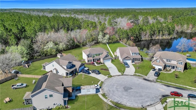 bird's eye view featuring a residential view, a view of trees, and a water view