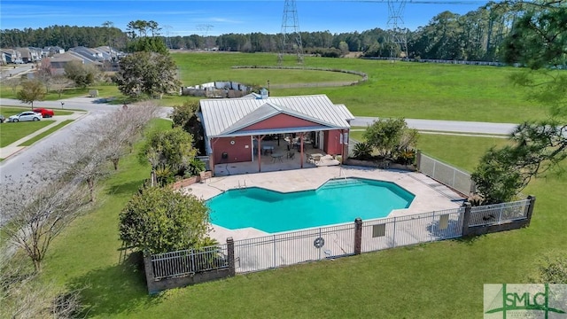 view of swimming pool featuring a patio area, a lawn, a fenced in pool, and fence