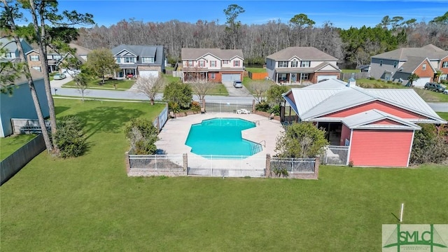 pool featuring a yard, a residential view, and a fenced backyard