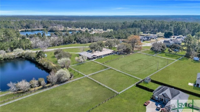 birds eye view of property featuring a water view, a rural view, and a wooded view