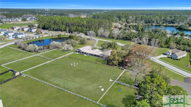 drone / aerial view featuring a forest view and a water view