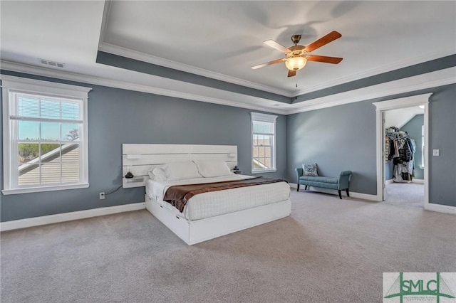 bedroom featuring visible vents, baseboards, a raised ceiling, and carpet