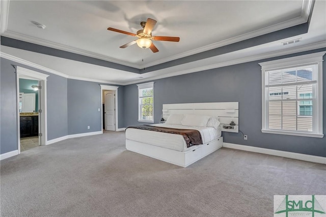 unfurnished bedroom with carpet flooring, visible vents, a raised ceiling, and baseboards