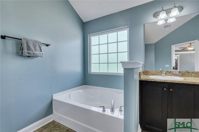 bathroom with a bath, baseboards, ceiling fan, vanity, and vaulted ceiling