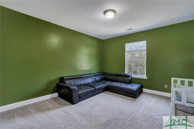 living area with visible vents, baseboards, and carpet floors